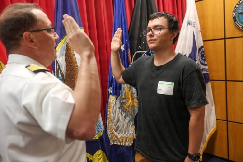 Navy captain gives oath of enlistment to son on last day of service